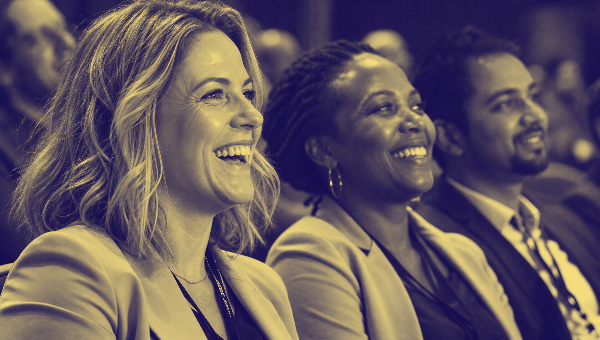 Mixed conference audience reacting to a live event in Chaos Theory deep purple and pale-yellow duotone