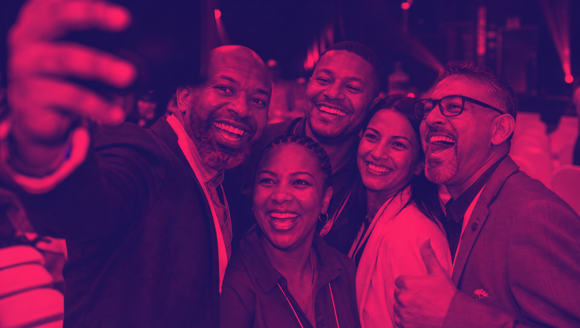 Corporate event group sharing a celebratory roadshow moment in Chaos Theory duotone