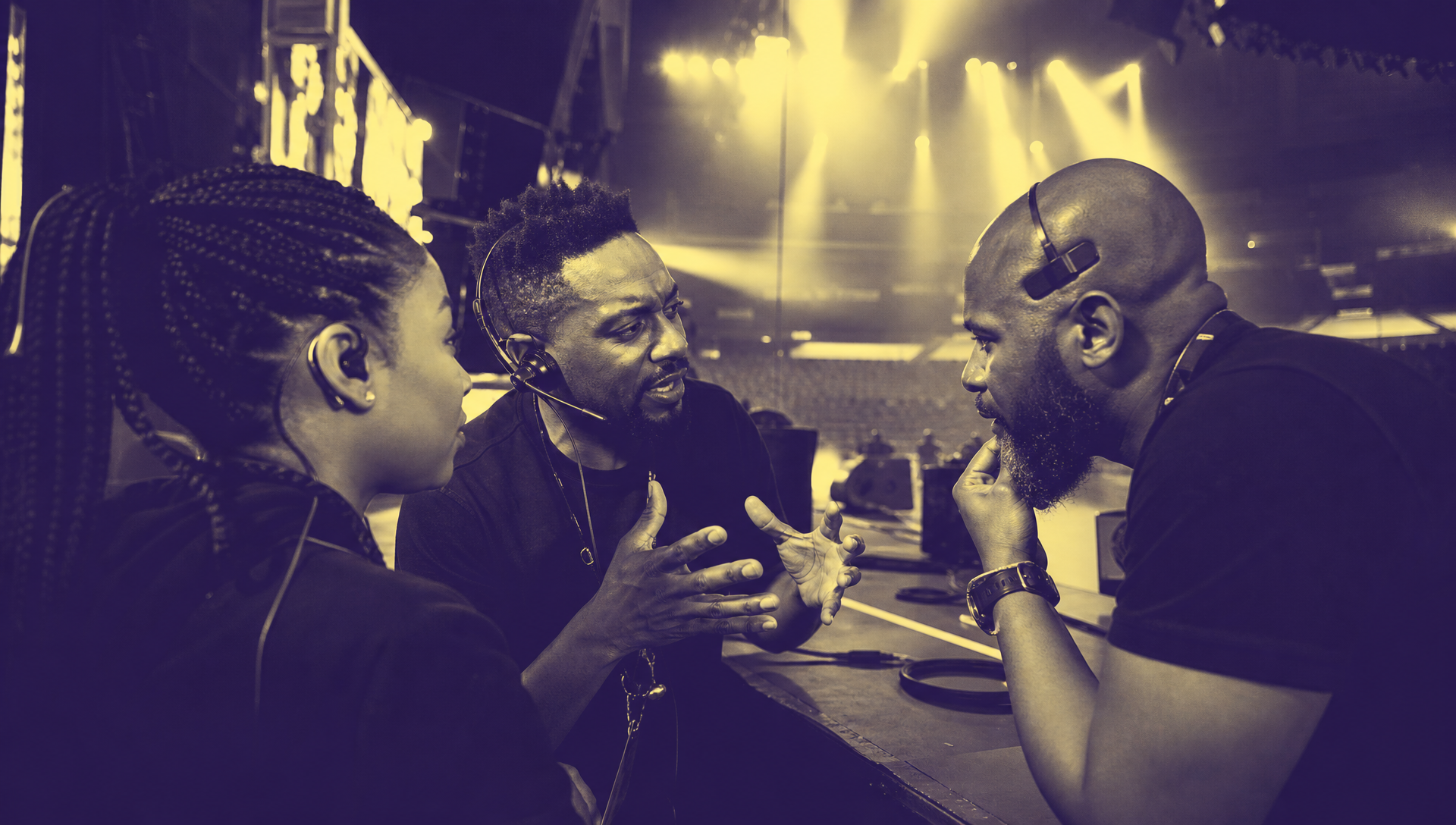 Event team in a focused pre-show strategy huddle in Chaos Theory duotone